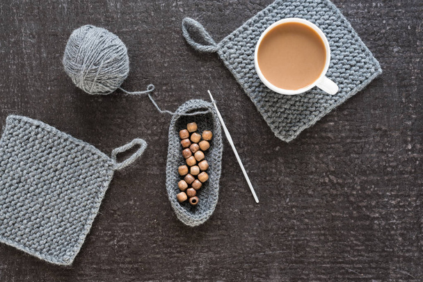 Coffee, wooden beads and crocheting on black - Fotó, kép