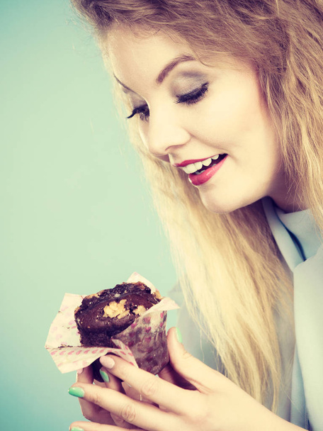 Attractive woman holds cake in hand - Photo, Image