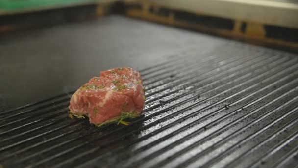 Beef steak is grilling at restaurant kitchen - Footage, Video