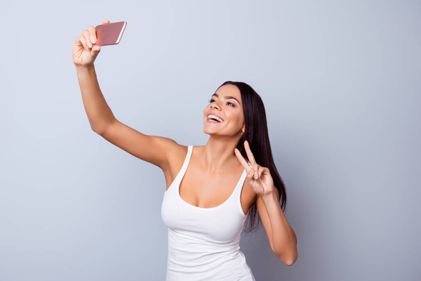 Close up portrait of cute excited latin girl making selfie with  - Photo, Image