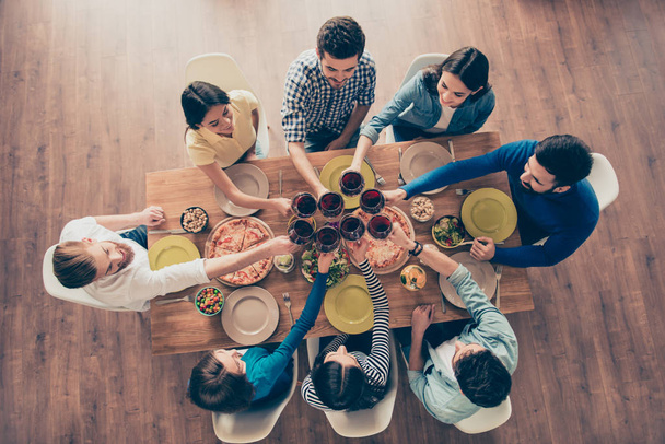 Top view of youth toasting. Eight multiethnic friends got togeth - 写真・画像