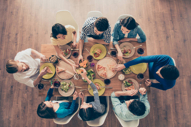 Top view of group of eight happy friends having nice food and dr - Foto, Bild