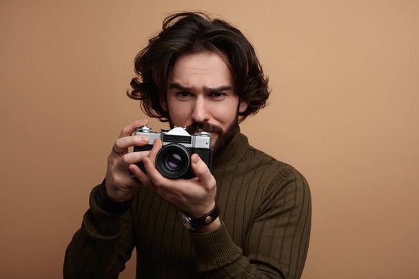 man in sweater holding retro camera - Photo, Image