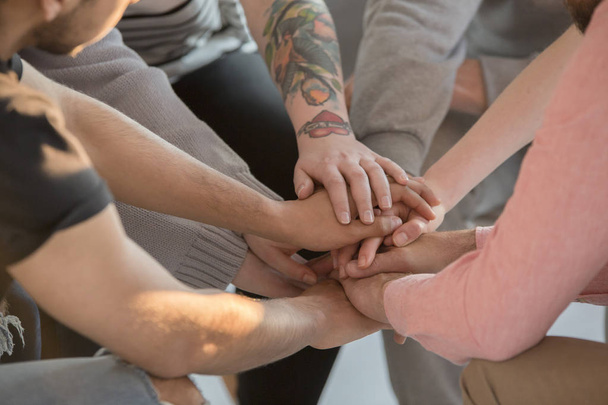 Group holding hands together - Фото, изображение