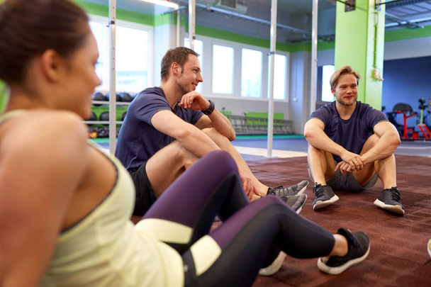 group of happy friends resting in gym - Foto, Imagem