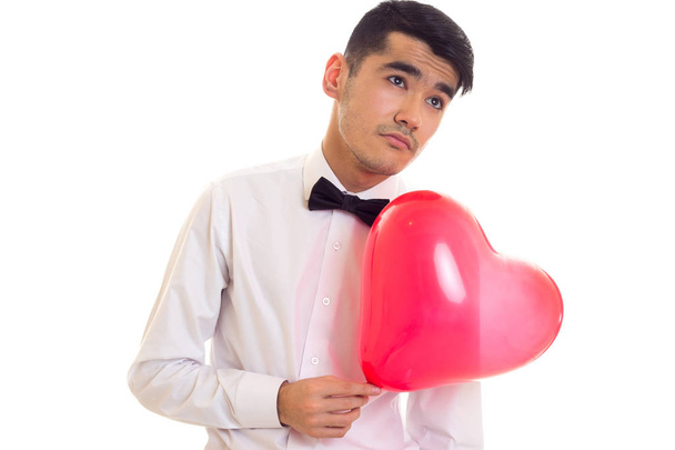 Jovem com laço segurando balão
 - Foto, Imagem