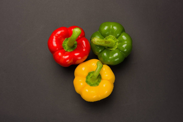 Τρεις πιπεριές σε μαύρο φόντο - Φωτογραφία, εικόνα