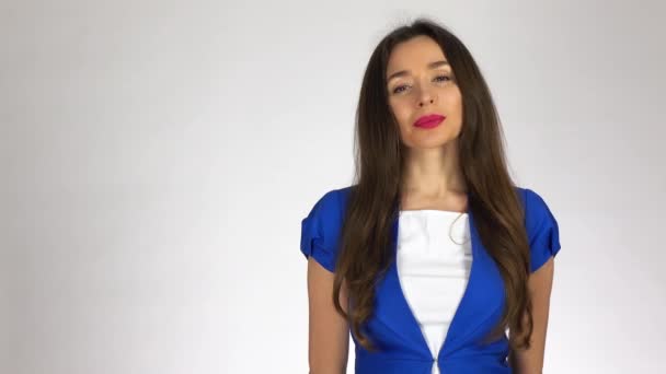 Portrait of beautiful young brunette woman against white background. 4K video - Video, Çekim