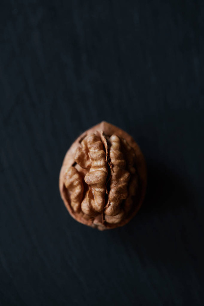 Walnut kernel on a slate backdrop - Фото, изображение