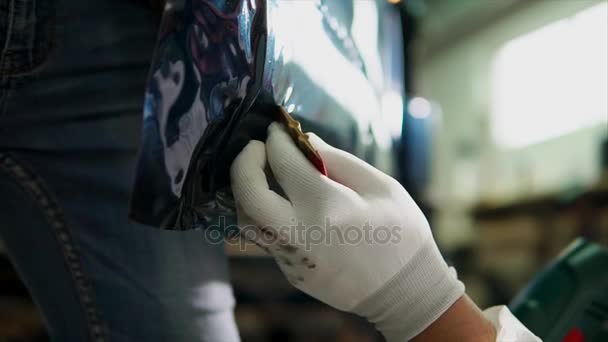 Close-up shot van deskundigen handen verwijdert luchtbellen terwijl het afstemmen van de auto - Video