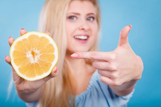 Woman pointing on grapefruit citrus fruit - Photo, Image