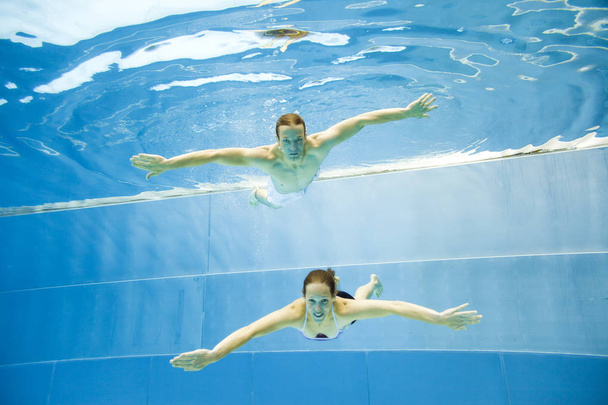 Podwodne widoki, Młoda para pływania w basenie - Zdjęcie, obraz
