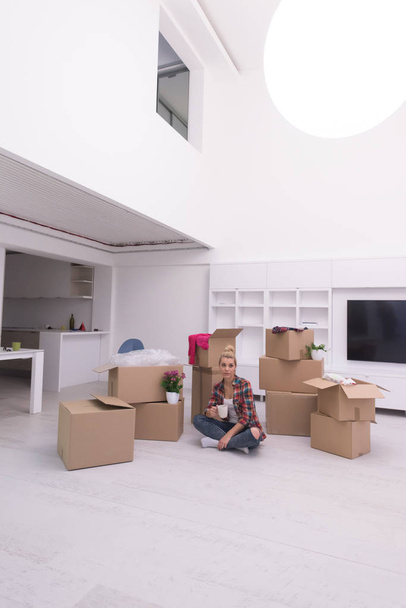 woman with many cardboard boxes sitting on floor - Foto, Imagem