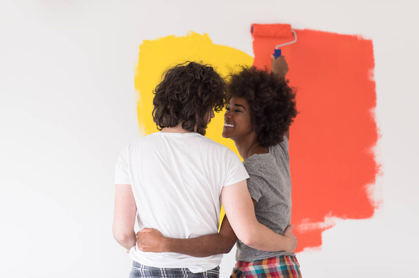 multiethnic couple painting interior wall - Foto, afbeelding
