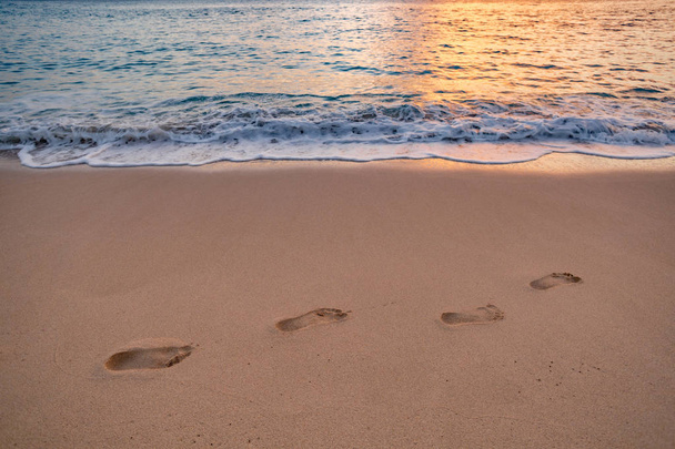 footprints on beach sand by the sea - Zdjęcie, obraz
