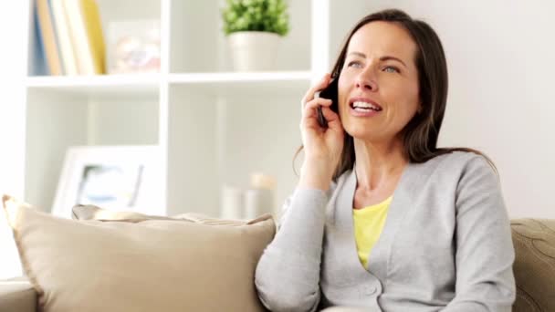 happy woman calling on smartphone at home - Video