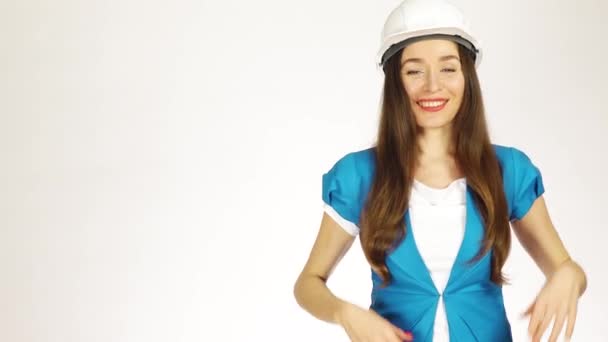 Happy female engineer or architect dancing against white background. 4K video - Metraje, vídeo
