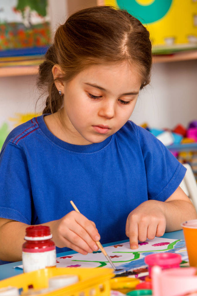 Small students girl painting in art school class. - 写真・画像