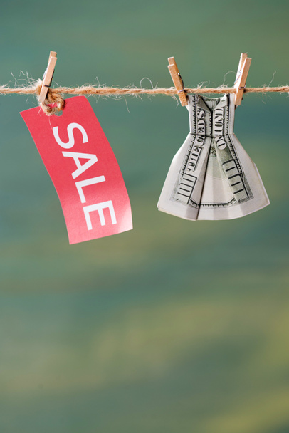 sale sign and dollar banknote on clothesline  - Photo, Image