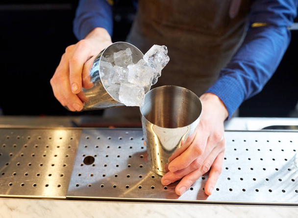 bartender with ice and shaker at cocktail bar - Φωτογραφία, εικόνα