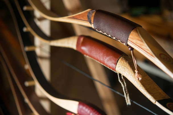 Wooden bows weapons for shooting close-ups - 写真・画像