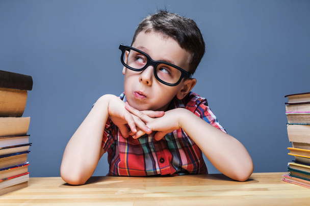 schoolboy in glasses sitting at desk  - Photo, Image