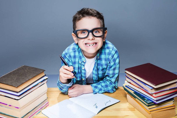 schoolboy doing homework in classroom - Photo, Image