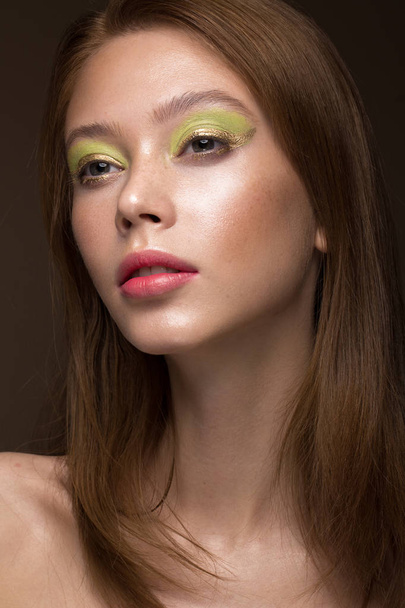 Beautiful red-hair girl with creative green makeup. Beauty face. - Fotó, kép