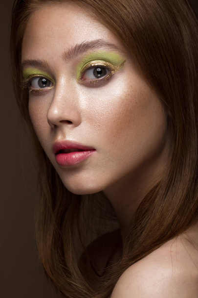 Beautiful red-hair girl with creative green makeup. Beauty face. - 写真・画像