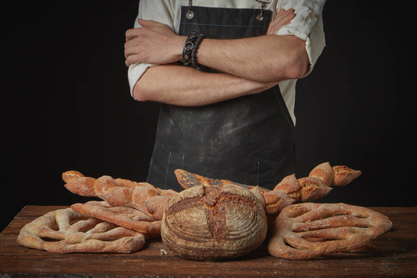 Baker with assortment of organic bread - Photo, image