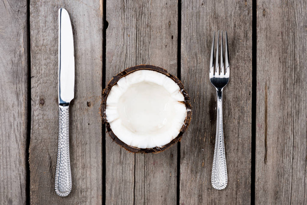 Coconut with fork and knife  - Foto, Imagen