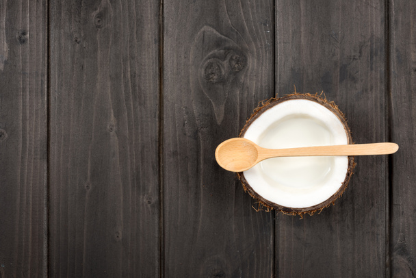 ripe coconut with milk and spoon - Zdjęcie, obraz