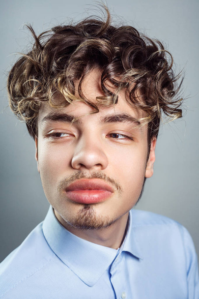Portrait of young man with curly hairstyle. studio shot. - Valokuva, kuva