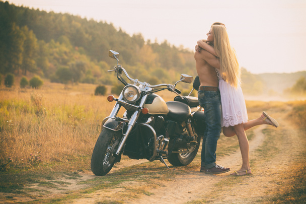 Lovers on a motorcycle in a field - Photo, Image
