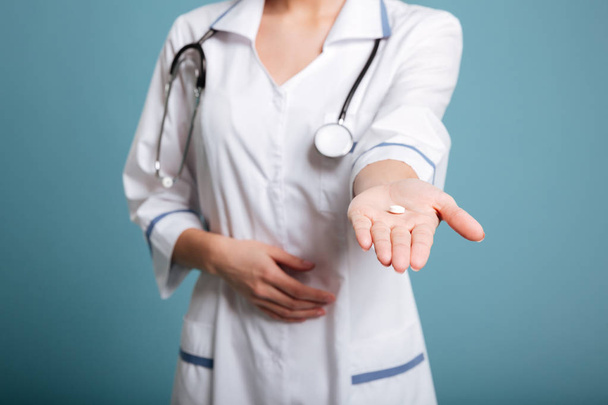 Shot of pill in nurses's hand isolated - 写真・画像