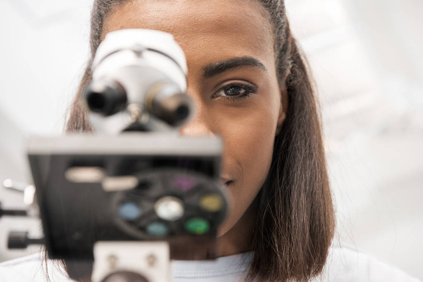 scientist looking through microscope - Photo, Image