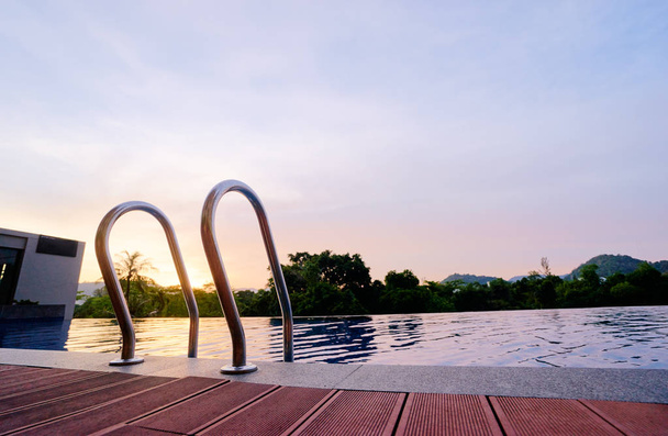 Swimming pool in sunset time. - 写真・画像