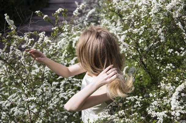 Spring Outfit girl onion with blond hair in the garden - Photo, Image