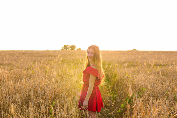 happiness, nature, summer, autumn, vacation and people concept - young woman in the field - Valokuva, kuva