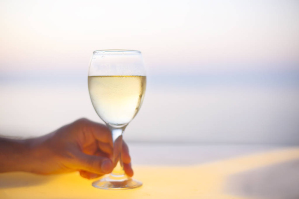 Relaxing man with glass of white wine on the beach  - Zdjęcie, obraz