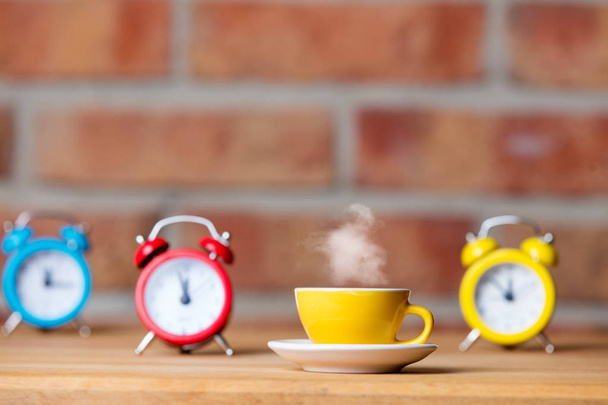 cup of hot tea and alarm clocks - Photo, Image