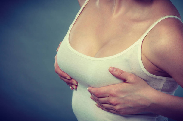 Woman holding hands on her breast - Photo, image
