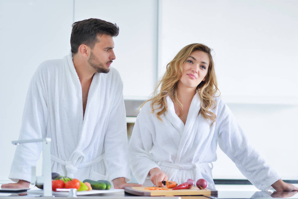 Happy couple cooking breakfast together  - Фото, изображение
