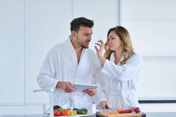 Couple in kitchen using tablet  - Zdjęcie, obraz