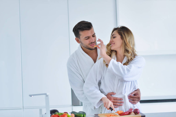 Happy couple cooking breakfast together  - Фото, изображение