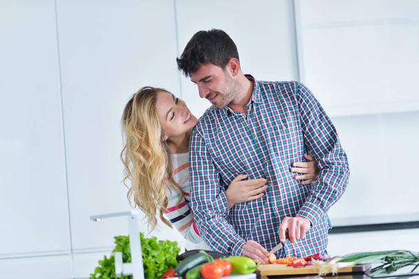 couple cooking food in kitchen - Photo, image