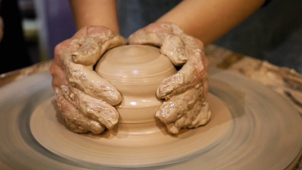 Potter is making clay pot on the potters wheel - Photo, Image