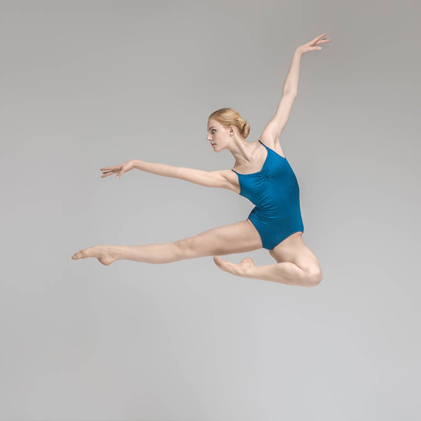 Ballerina posing in jump - Fotó, kép