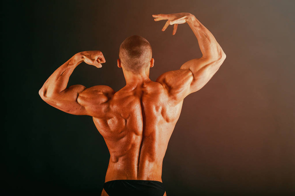 bodybuilder  on a dark background. - Fotó, kép