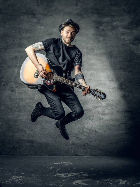 Guitar player in a jump - Foto, imagen